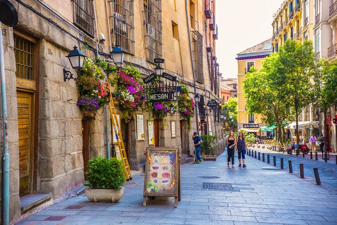 Don Quixote Quest Experience in Madrid - Puerta Cerrada: the medieval wall detail many people walk past